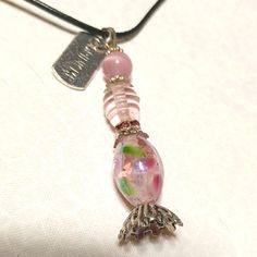 This Is A Beautiful, Handmade, Alice In Wonderland Pendant Necklace. The Lovely Potion Bottle Is Made With Gorgeous Glass Beads And A Pink Cats Eye Bead, With Silver Accent Beads, And It Comes With A Silver "Drink Me" Tag. It Even Has Tiny Pink Rhinestones!!! The Pendant Measures Approximately 2 1/4"X 1/2". It Comes With A Black Corded Necklace With An Extension. I Hope You Like It Too. Thanks For Stopping By And Feel Free To Leave Me A Fair Offer. Alice In Wonderland Potion, Potion Necklace, Corded Necklace, Drink Me, Potion Bottle, Cats Eye, Gorgeous Glass, Pink Cat, Pink Rhinestones