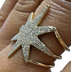 This stunning 14kt yellow gold star shaped ring is a must-have for any jewelry collection. The starburst triple band design with pave setting style is adorned with 158 natural white diamonds, totaling 0.30ctw in weight. The ring is a size 6.75. The ring's band width ranges from 9.3mm to 12.8mm, and the metal purity is 14k. This fine jewelry piece is a great addition to any collection and is sure to make a statement.C-BMH-0828  ------------------------------------------------------ Specification: ------------------------------------------------------   Category Style: Triple Band      Brand: Unbranded   Metal Purity: 14k Base Metal: Gold  Ring Size: 6.75    Main Stone: Diamond Main Stone Color: White Main Stone Shape: Round             Internal ID: 39841 Triple Band Ring, Gold Starburst, Band Design, Ring Pictures, Pave Setting, Gold Star, Multi Stone Ring, Multi Stone, White Diamonds