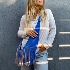 Vibrant and show-stopping, this bag will have people stop and stare... and then ask you where they can get one. Made from our supple and durable faux leather. Features silver hardware. Fringe disclaimer: The fringe embellishment is not covered under the manufacturing warranty. Sash is not responsible for lost or damage fringe that occurs after delivery. Blue Rectangular Bag For Fall, Rectangular Blue Bag For Fall, Blue Shoulder Bag For Daily Use In Fall, Blue Bags With Adjustable Strap For Fall, Blue Bag With Adjustable Strap For Fall, Blue Fringe Bags For Daily Use, Blue Fringe Tote Shoulder Bag, Fall Travel Blue Shoulder Bag, Trendy Blue Bags For Fall