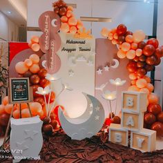 a baby shower with balloons and decorations on the bed in front of it is an orange theme