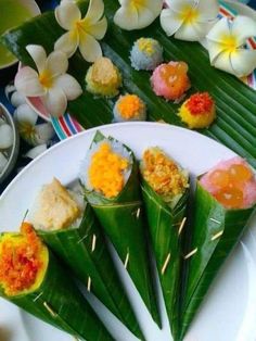 some food is sitting on a plate with flowers and leaves around it in the background