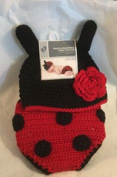 a red and black crocheted bag with a ladybug design on it