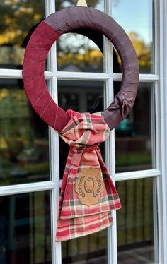 a wreath hanging on the side of a window