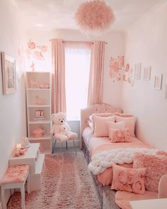 a bedroom with pink and white decor on the walls