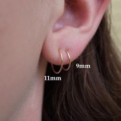 • Two sets of Tiny Hoop Earrings • (4 earrings in total) • 14K gold-filled or sterling silver. When you select a quantity of '1' you will receive two pairs of hoops. - The model is wearing 9mm and 11mm hoops. - You'll receive one set of 9mm hoops and one set of 11mm hoops unless you choose custom sizes. - If you want custom sizes, write them in "notes to seller" upon purchase. - Sizes 8mm - 11mm available. Purchase Hoops Individually: https://www.etsy.com/listing/791336853/gold-mini-hoops-14k-gold-filled-20g Perfect for every-day wear, the kind of earrings you leave in for weeks if not months. These hoops can be worn in the ear, tragus, nose, lip, or cartilage. High-quality, simple, and versatile. -20 gauge wire (this is the thickness of the wire itself, the 'size' of the hoop refers to th Luxury Gold Huggie Earrings With Ear Wire, Small Loop Earrings, Tiny Gold Hoop Earrings, Little Hoop Earrings, 4 Earrings, Xmas 2024, Sleeper Earrings, Tiny Hoop Earrings, Cartilage Hoop