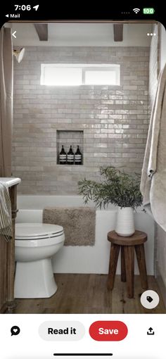 a white toilet sitting next to a bath tub in a bathroom on top of a hard wood floor