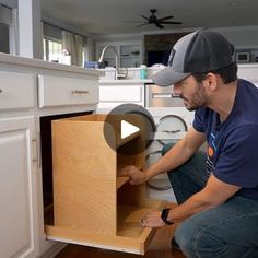 a man kneeling down in front of an open cabinet