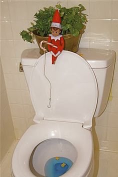 an elf is sitting on top of a toilet in the bathroom with plants growing out of it