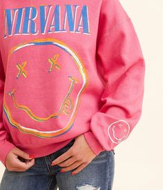 Merch Traffic Nirvana® Smiley Face Pullover - Pink Small, Women's Rougered Graphic washed fleece lined pullover Sleeve hit Bust measures 44 on size small Body length 24 on size small. 50% Cotton 50% Polyester. Machine wash cold. Do not bleach. Tumble dry low. Do not iron decoration. Apparel & Accessories > Clothing > Shirts & Tops Cheap Pink Smiley Face Tops, Fun Pink Smiley Face Tops, Pink Nirvana Crewneck, Nirvana Smile Overdyed Sweatshirt, Nirvana Hoodie Pink, Nirvana Smiley Face, Women's Sweatshirts, Iron Decoration, Accessories Clothing