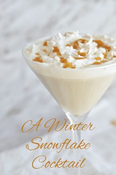 a drink in a martini glass with whipped cream on top and the words, a winter snowflake cocktail