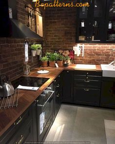 a kitchen with black cabinets and wooden counter tops