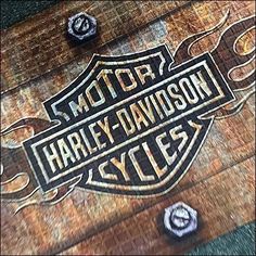 the harley davidson logo is painted on wood