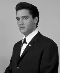 a black and white photo of a man in a suit