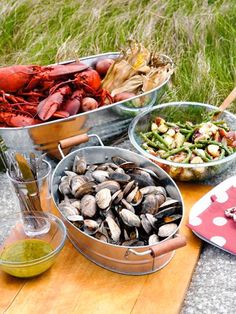 several different types of food are on the table together, including clams and shrimp