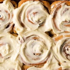 cinnamon rolls with cream cheese frosting in a pan