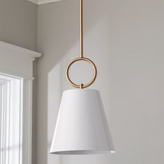 a white lamp hanging from a ceiling in a room