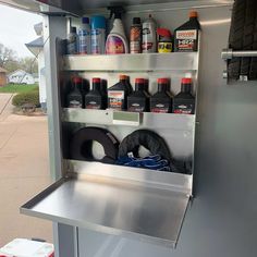 the inside of a truck with bottles and other items in it's storage compartment