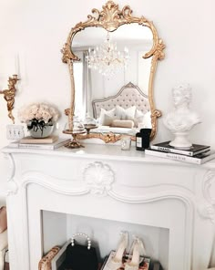 a white fireplace with a mirror and some shoes on it next to a vase filled with flowers