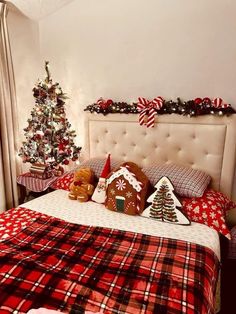 a bedroom decorated for christmas with gingerbread houses on the bed