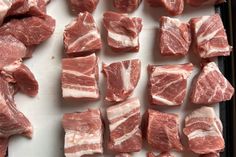 raw meat sitting on top of a cutting board