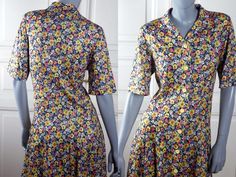 This 1990s Finnish vintage floral dress has a notch collar and padded shoulders. The multicolor dress has a full bouquet of colors (yellow, purple, red, green, white) on a black background. The short-sleeve below-the-knee spring/summer dress closes in the front with nine yellow buttons. The stunning dress has a dropped waistline with wide pleats that gives way to a slightly flared skirt.  Size Medium, 8 US, 12 UK Bust = 36 inches (91cm) Waist = 33 inches (84cm) Hips = 39 inches (99cm) Sleeve Len Retro Collared Multicolor Dresses, Fitted Collared Dress For Garden Party, Vintage Multicolor V-neck Dress, Vintage Collared Floral Print Dress, Fitted Multicolor Dress With Vintage Print, Retro Collared Floral Print Dresses, Retro Floral Print Collared Dress, Retro Collared Dresses With Floral Print, Retro Collared Dress With Floral Print