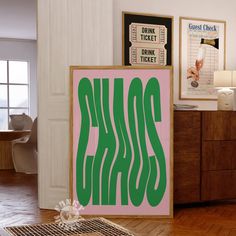 there is a pink and green sign on the floor in front of a dresser with posters