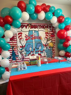 the dr seuss birthday party is set up with red, white and blue balloons