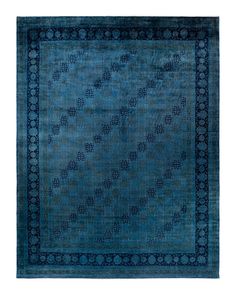 a blue rug with an intricate design on the middle and bottom, surrounded by smaller circles