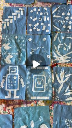 some blue and white paper cut out into squares with pictures on them, including an image of a robot