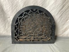 an old cast iron grate sitting on top of a white sheet