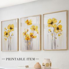 three yellow flowers are hanging on the wall next to a vase and two pictures that say printable items