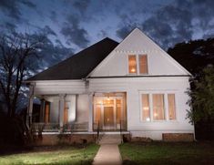 a white house is lit up at night