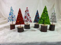 several small trees made out of glass on top of a table