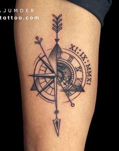 a black and white photo of a compass tattoo