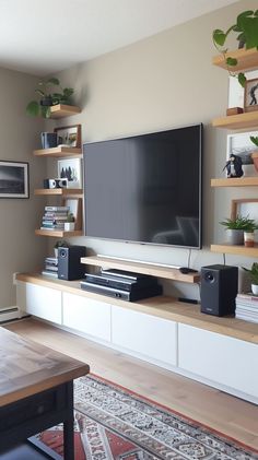 a flat screen tv sitting on top of a wooden entertainment center in a living room