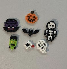 six perler bead halloween decorations on a white surface