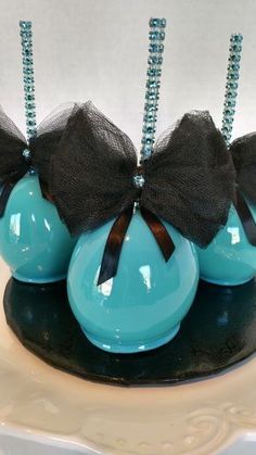 three blue vases with black bows on them