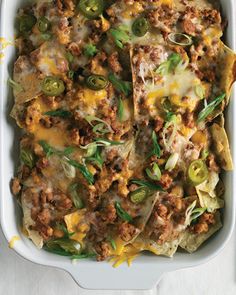 a casserole dish with meat, cheese and green peppers