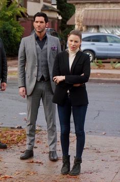 a man and woman walking down the street