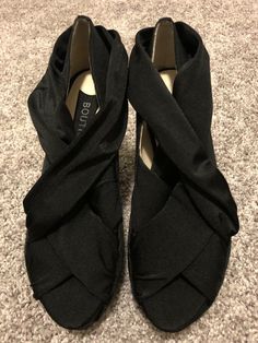 Up for auction is an new (without box) pair of ladies size 7.5 Boutique 9 "Gibsin" fabric, crisscross wedge, open toe shoe. They have never been worn.  In my opinion, these are a bit on the narrow side and run small.  I am a true 7.5 and these are a bit snug. My feedback is 100% positive so you can be sure to bid with confidence.  I strive to ship the same day as payment is received so you will have this item as quickly as possible.  Your item will be shipped via USPS with tracking information p Fabric Heels With Wrapped Heel And Round Toe, Party Fabric Wedge Heels, Elegant Black Fabric Heels, High Heel Fabric Wedge Sandals With Platform, Fabric Block Heel Shoes For Formal Occasions, Formal Fabric Block Heel Shoes, Chic Fabric Wedge Heel Sandals, Chic Black Fabric Heels, Fabric Open Toe Sandals With Wrapped Heel