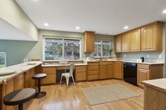 a kitchen with wooden cabinets and white counter tops