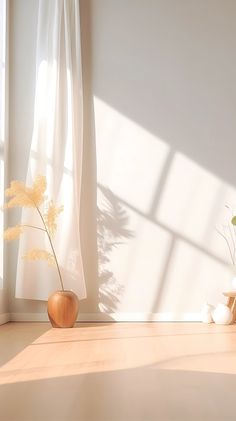 a vase with some flowers in it sitting on the floor next to a curtained window