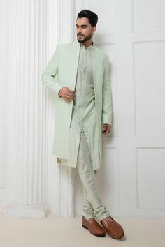 Mint green sherwani jacket with self thread work. Paired with a kurta and churidar. - Aza Fashions Green Fitted Kurta With Naqshi, Pista Green Nehru Jacket For Designer Wear, Fitted Green Bandhgala With Naqshi Detailing, Fitted Green Bandhgala With Naqshi, Formal Pista Green Sherwani With Chikankari Embroidery, Pista Green Sherwani With Chikankari Embroidery For Formal Occasions, Fitted Green Nehru Jacket With Dabka Detailing, Green Long Sleeve Bandhgala With Naqshi, Fitted Green Nehru Jacket For Eid