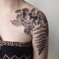 a woman's chest with flowers and leaves on it