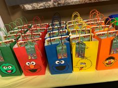 sesame street bags are lined up on a table