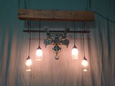 a light fixture with four lights hanging from it's sides and two bulbs on each side