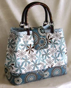 a blue and white purse sitting on top of a table