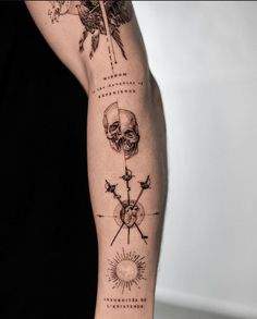 a person with a tattoo on their arm has a skull and cross tattoos on it