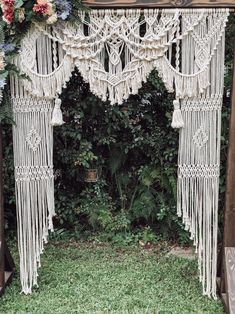 an outdoor wedding ceremony with macrami and flowers