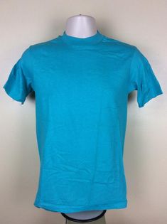 Vintage 80s Hanes plain turquoise t-shirt.  Soft 100% cotton, made in USA.Excellent condition, like never worn.  No holes, no stains, no issues.Size S, but fits slightly smaller than today’s S.  Please note measurements to avoid returns: laid flat measures 17” across chest (armpit to armpit), 26.5” length (top of center of collar on back to bottom of shirt). Turquoise Crew Neck T-shirt For Summer, Casual Turquoise Crew Neck T-shirt, Turquoise Cotton Crew Neck T-shirt, Turquoise Cotton Short Sleeve T-shirt, Plain White T's, Kenny Loggins, Milla Jovovich, Buffalo Ny, Concert Tshirts